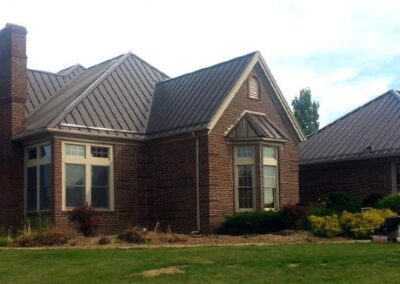 a brick home with a metal roof
