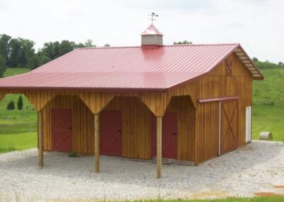 a small barn with a red roof and a red roof