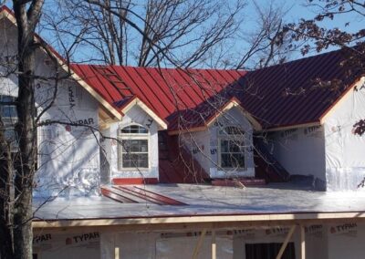 a house with a red roof being installed
